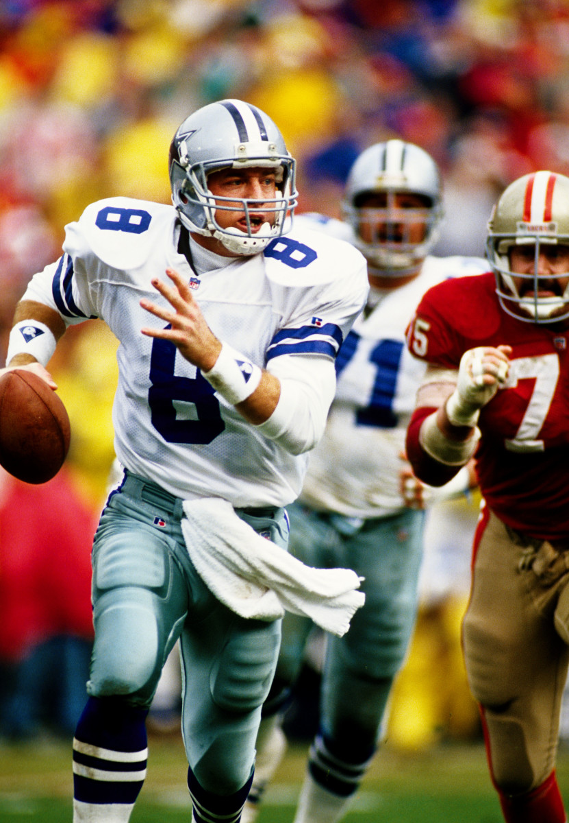 Jan 17, 1993; San Francisco, CA, USA; FILE PHOTO; Dallas Cowboys quarterback Troy Aikman (8) scrambles under pressure from San Francisco 49ers defensive end Kevin Fagan (75) during the 1992 NFC Championship game at Candlestick Park. Mandatory Credit: Peter Brouillet-USA TODAY NETWORK